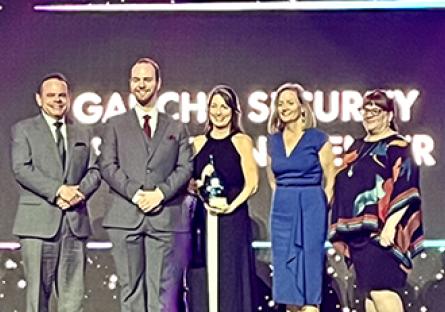 Receiving the award are Drew Nichols - Lead Engineer GSOC, Chad Stroot - Lead Analyst GSOC, Rachelle Hall, Susan Campbell, and Tiffany Hernandez.