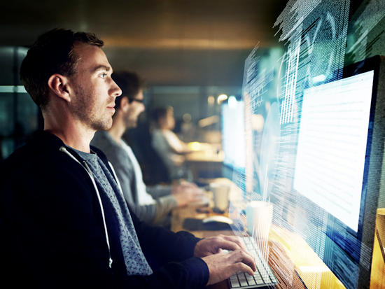 A picture of a person coding software.