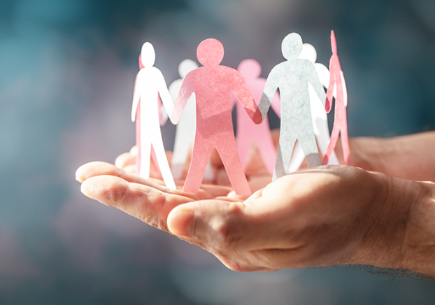 Paper doll chain being held in two outstretched hands