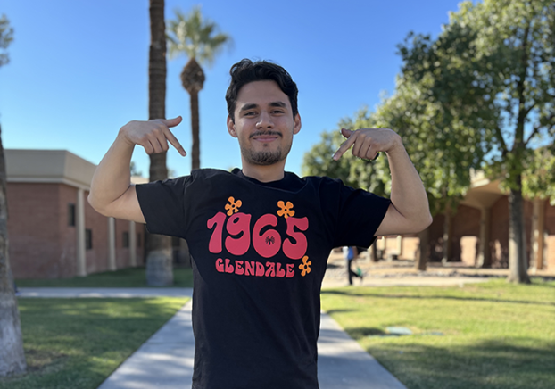 Smiling GCC student wearing our black 60th Anniversary T-shirt