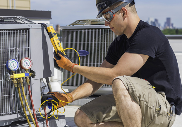 HVAC/R Technician working on an air conditioning unit.